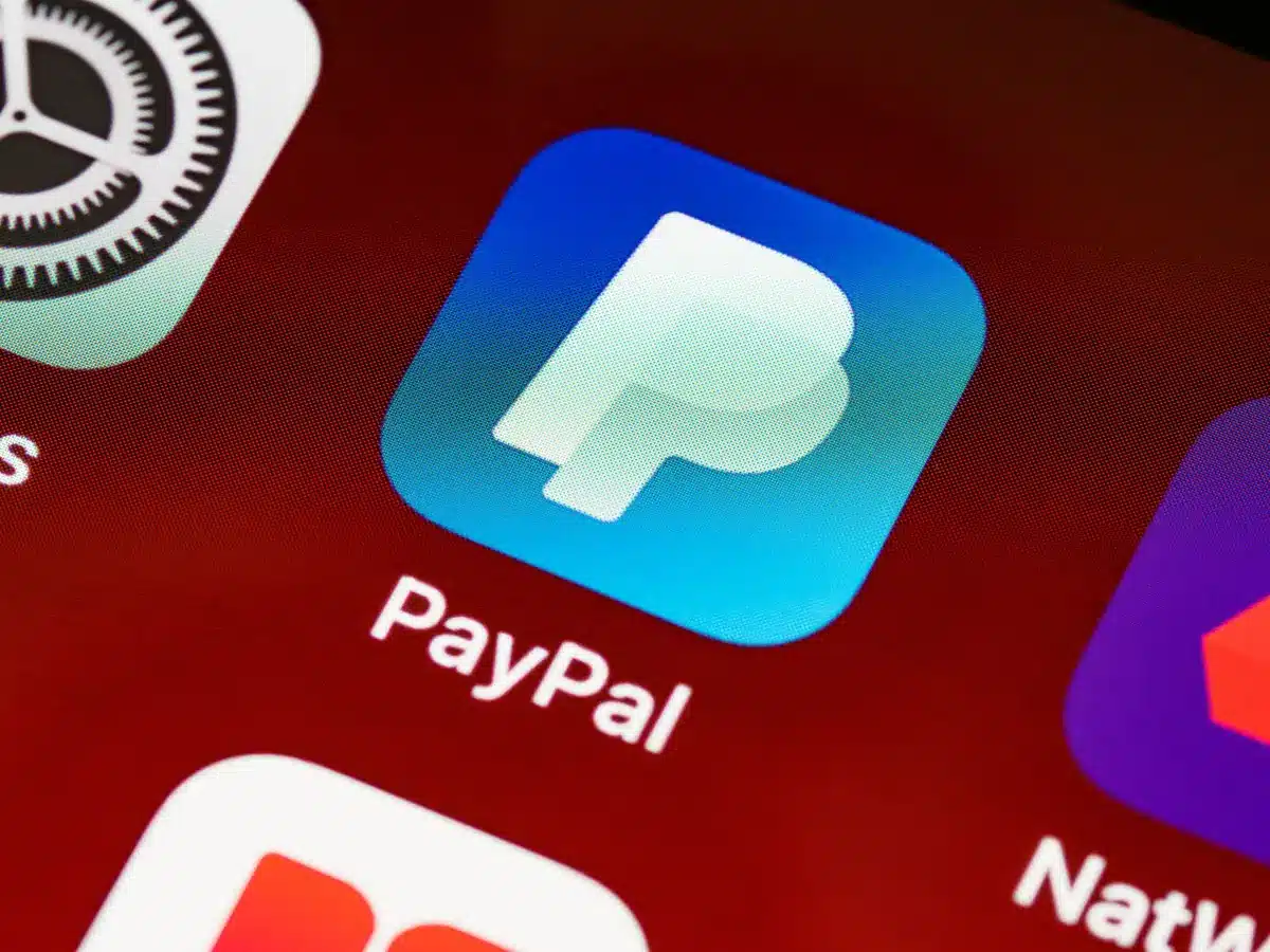 PayPal notification on smartphone screen, settlement fund deposit confirmation visible